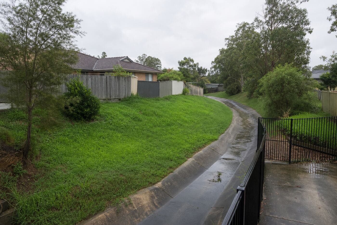 Stormwater corridor behind suburban houses