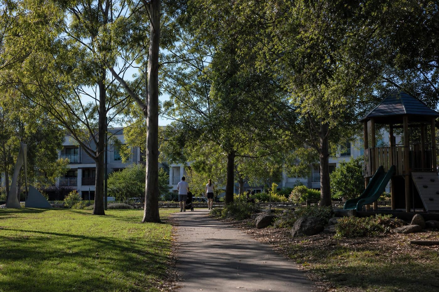 Leafy Australian suburban park with homes beyond the trees